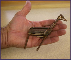Replica of a split-twig figurine believed to represent a deer. Replica created by Paul Ermigiotti. Photo by Joyce Heuman Kramer; copyright Crow Canyon Archaeological left.