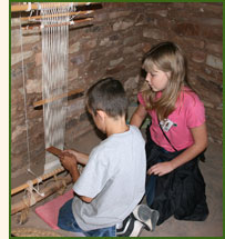 Students learning how to weave on a Pueblo loom at Crow Canyon.