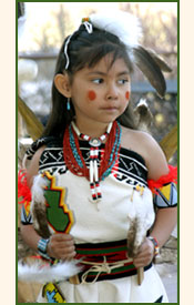 Pueblo girl dancing in traditional costume.