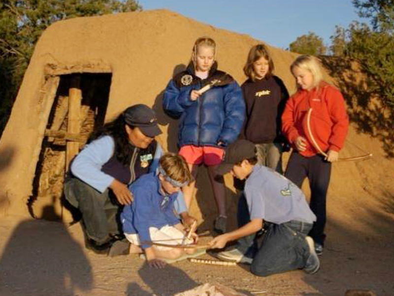 Students at the replica pit house learning center